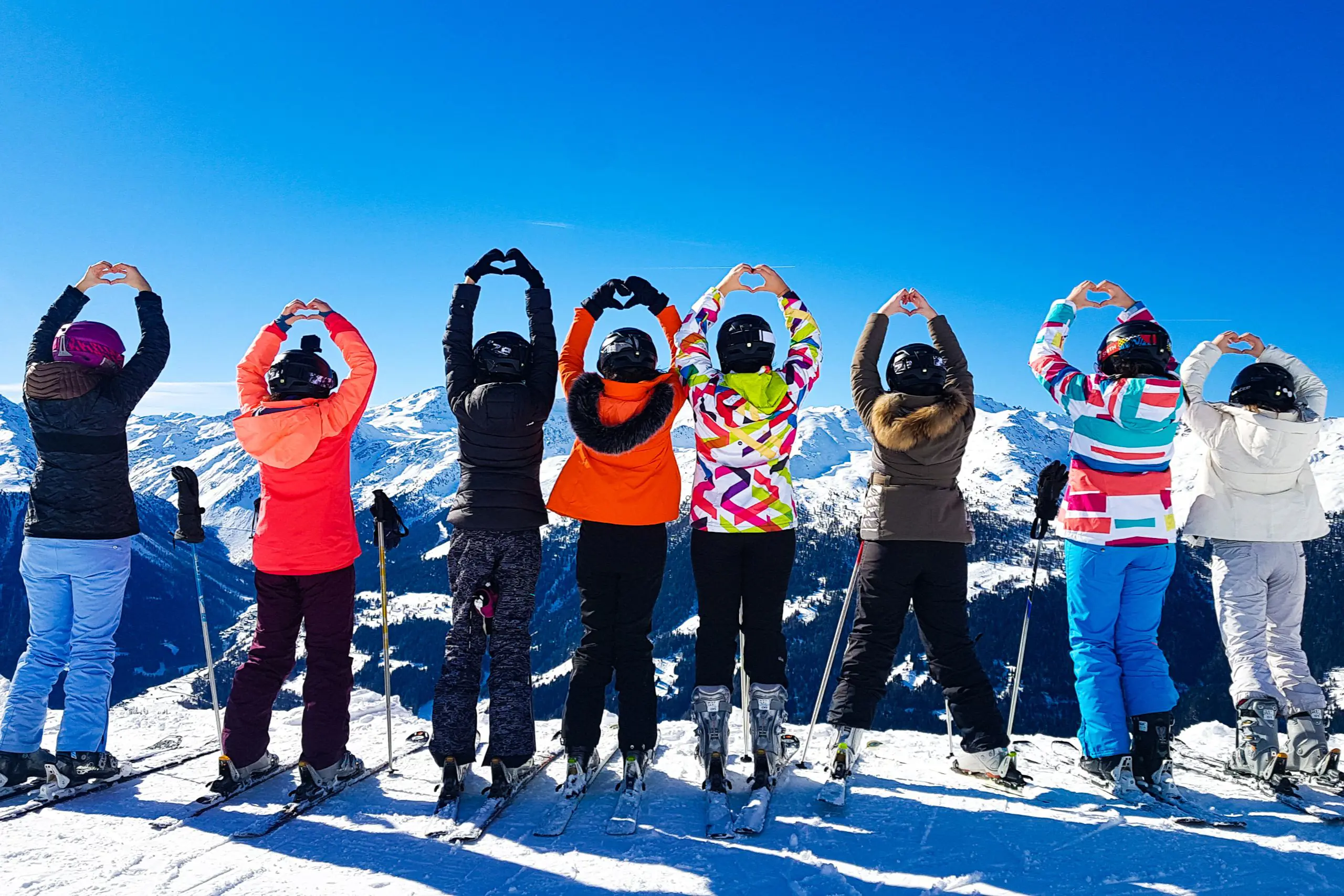Group of skiers looking out over the mountains